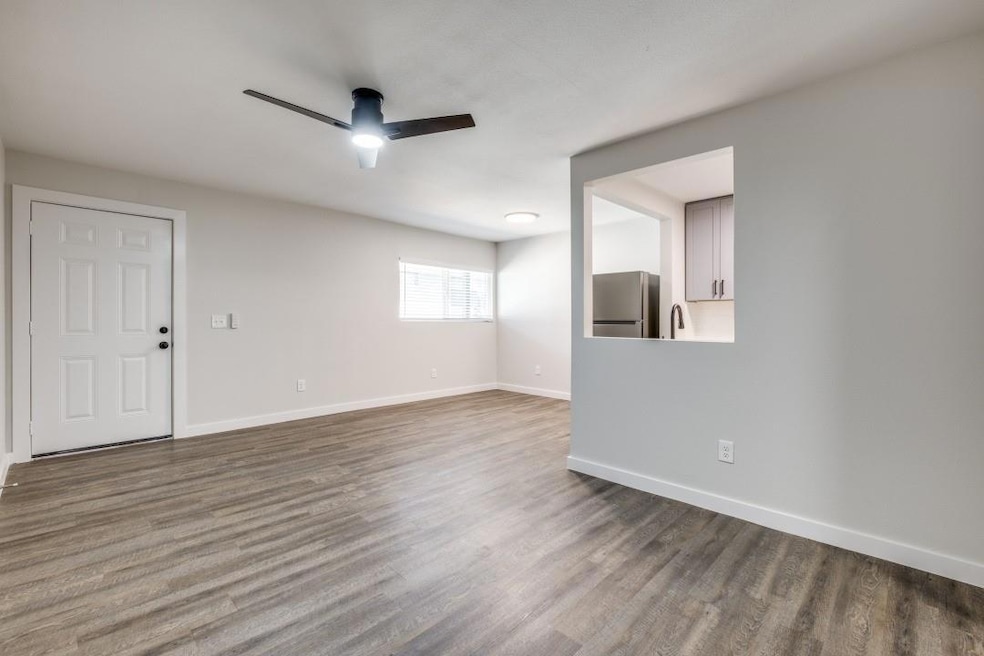 Empty room featuring sink, wood-type flooring, and
