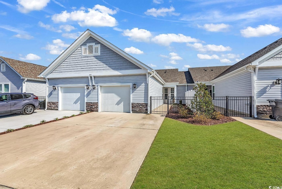 View of front of home with a front yard, fence, dr