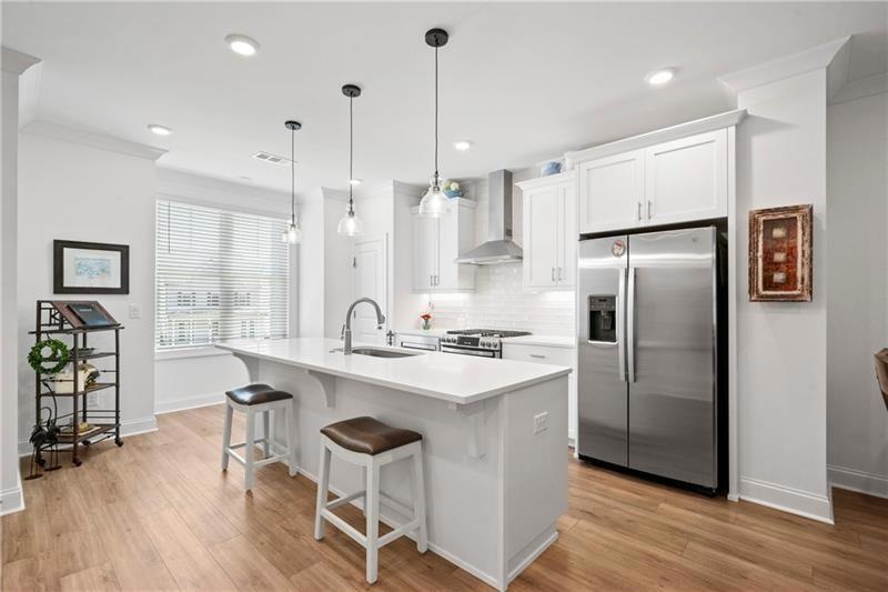 Kitchen featuring large single sink, wall chimney 