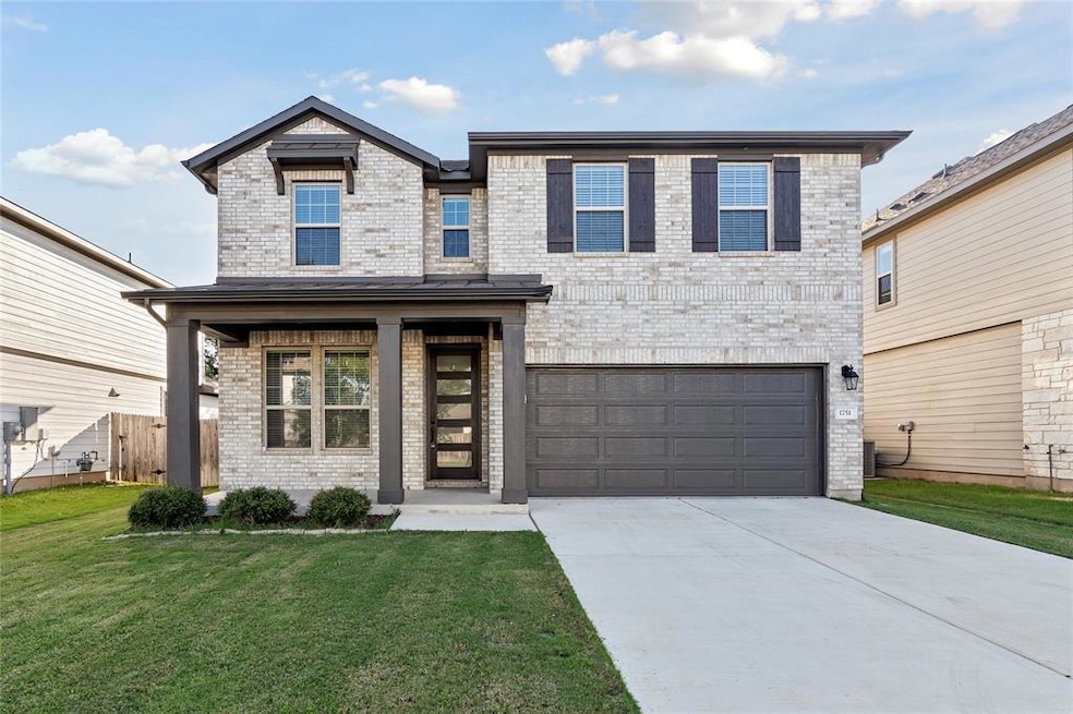 View of front of house with a front yard, an atta
