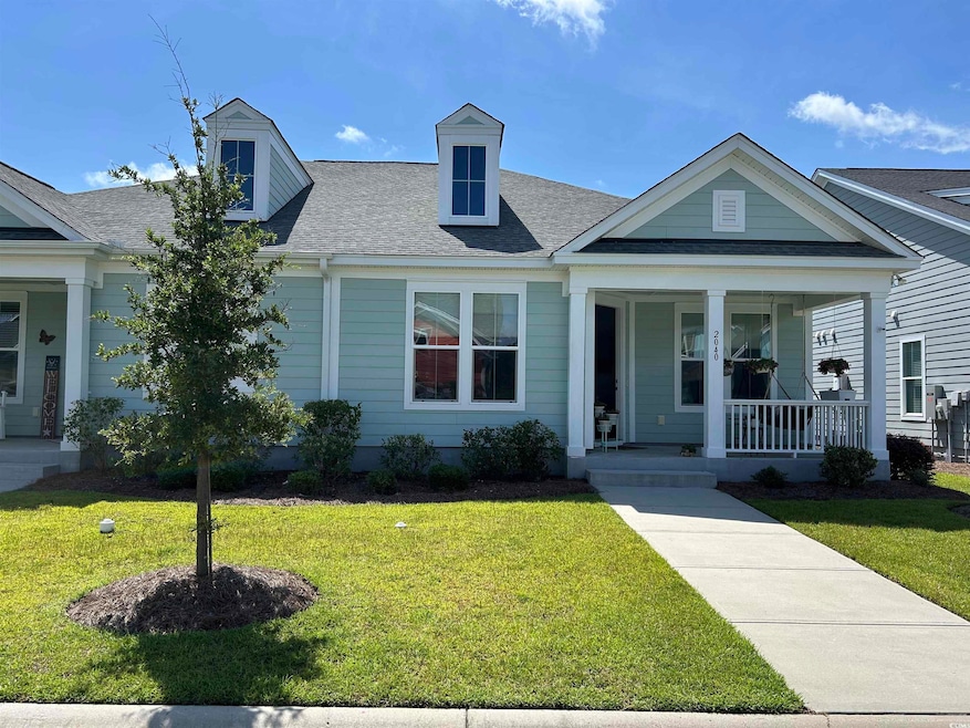 View of front of house featuring covered porch with a cozy swing to relax.