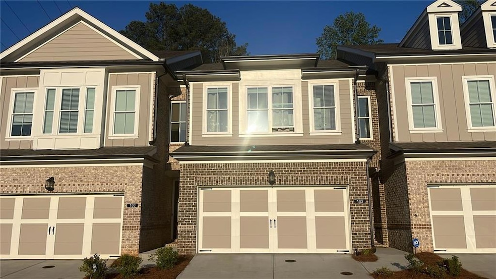 View of front of house featuring a garage, brick s