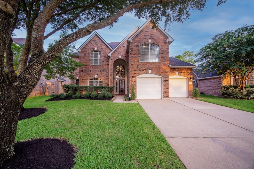 Welcome to 13711 Layton Hills presenting truly stunning curb appeal with mature oaks and dramatic landscape lighting.