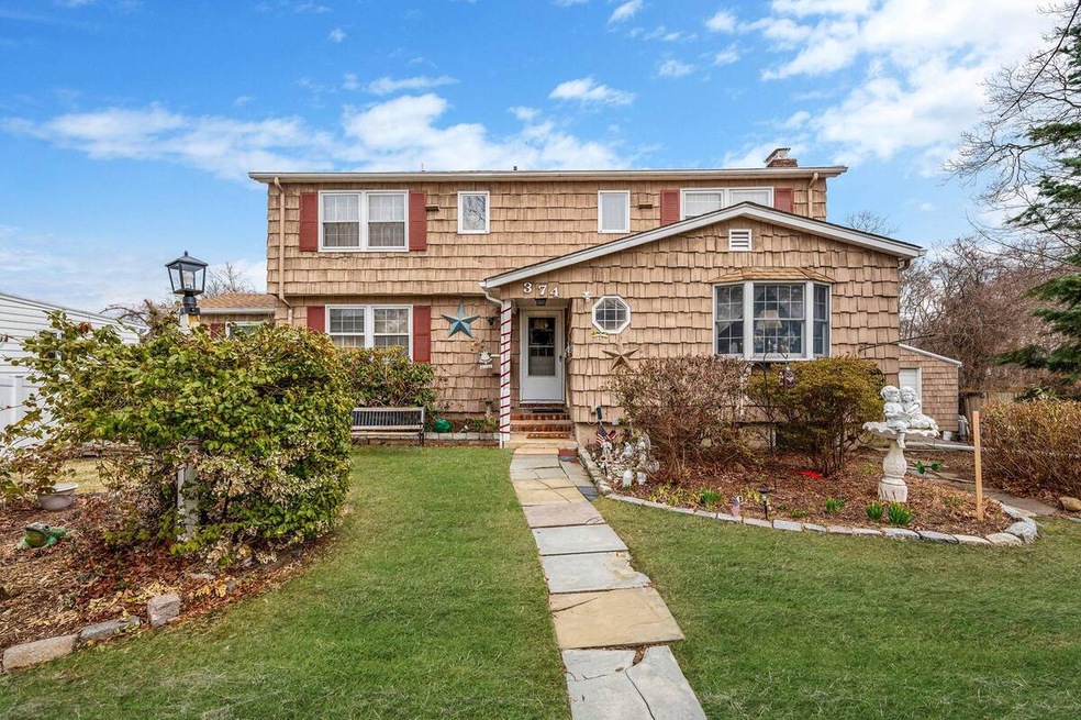 View of front of home with a front yard, entry ste