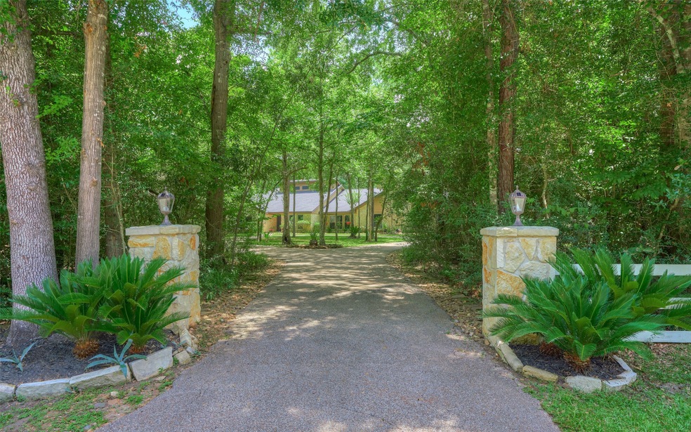 Beautiful custom home in the prestigious gated community of Teaswood on almost one acre. Come enjoy the serenity of the mature trees, corner lot and the great circle driveway.