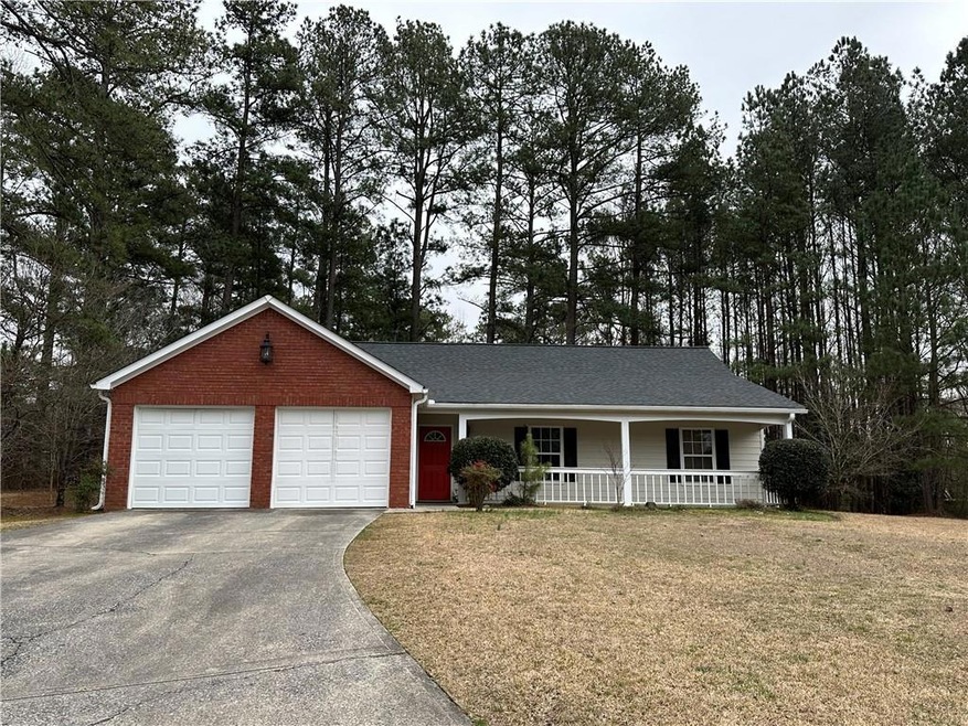 Ranch-style home with a garage, a front yard, and 