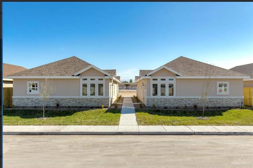View of front of house with stone siding, stucco siding, and roof with shingles