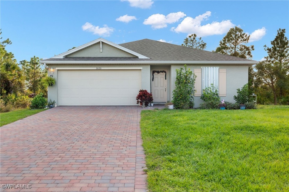 Single story home featuring a garage and a front y