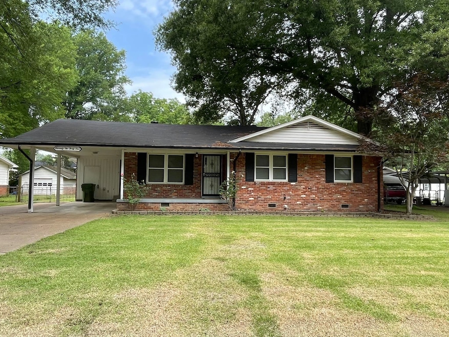 Single story home featuring crawl space, a front lawn, brick siding, concrete driveway, and a carport