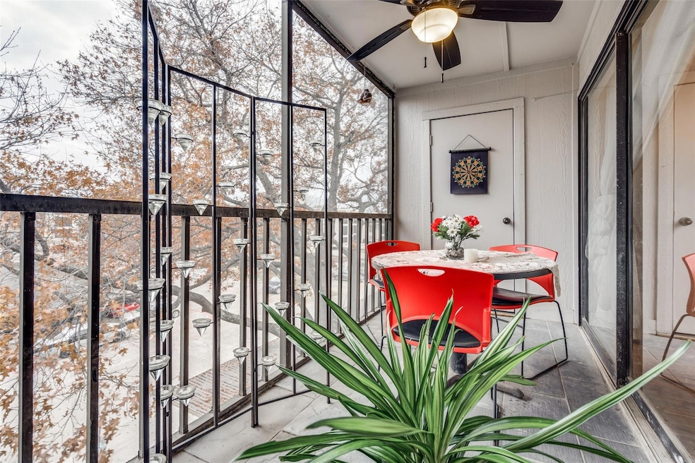 Unfurnished sunroom featuring ceiling fan and a he
