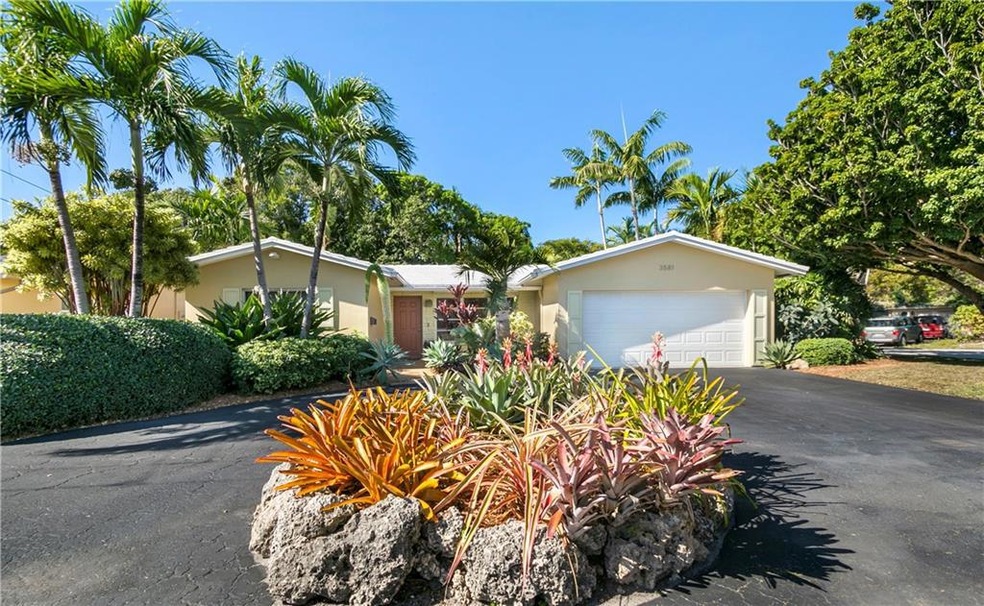 Stellar landscaped corner lot with circular drive.