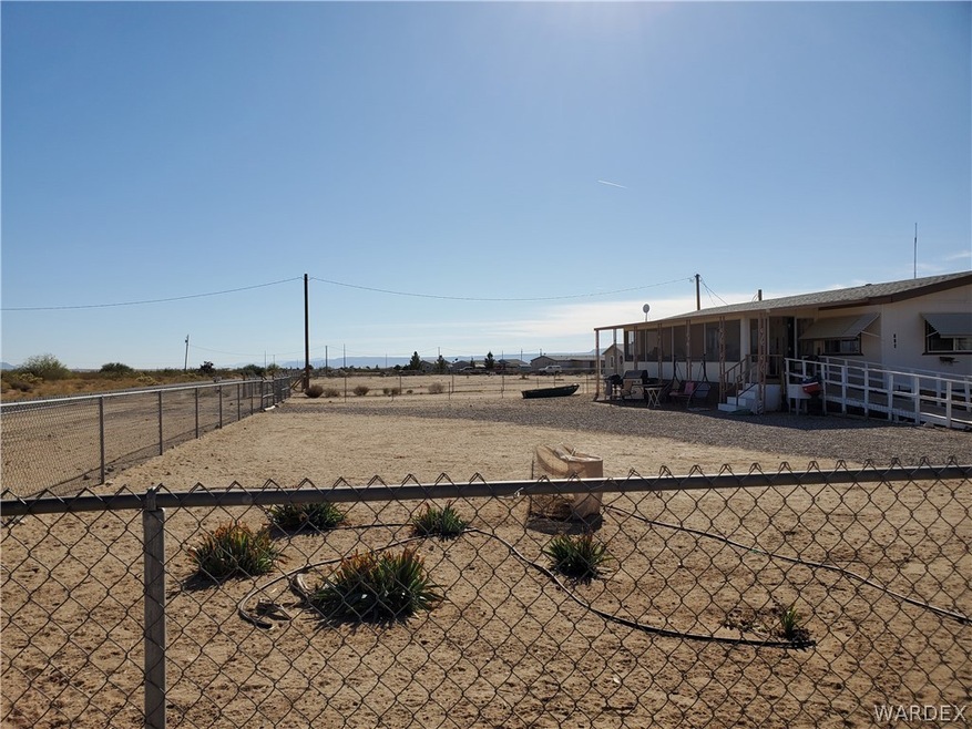 Fully fenced front yard viewed from Collins