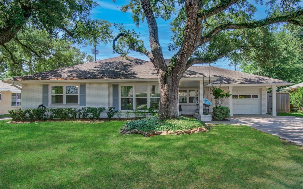 Gorgeous mature oaks frame this classic ranch styl