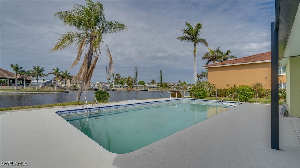 View of pool featuring a water view and a patio ar