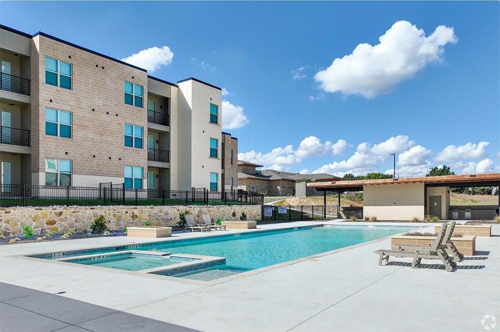 View of pool featuring a community hot tub and a p