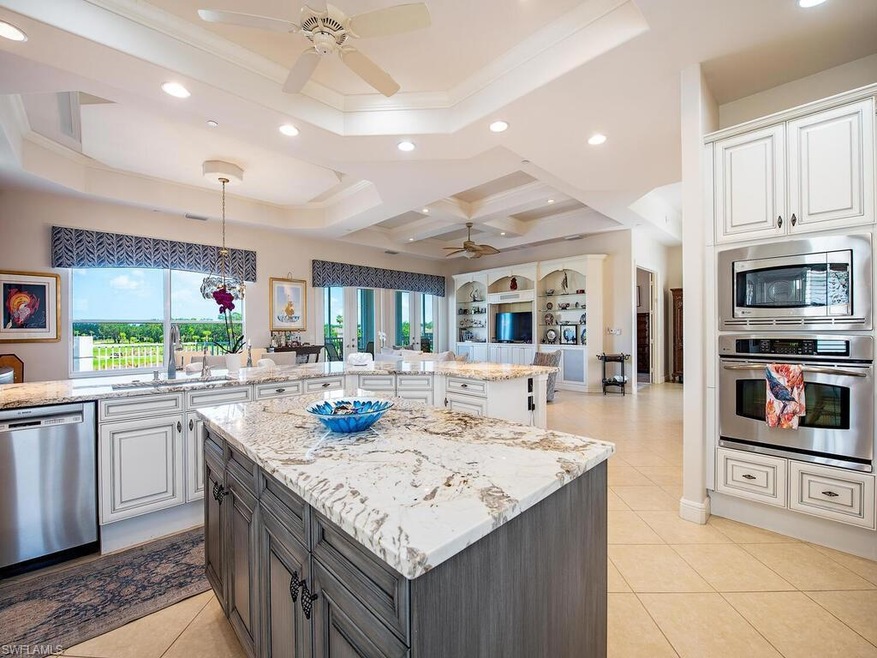 Lovely renovated open kitchen with two-tone cabinetry with pullouts and added pantry