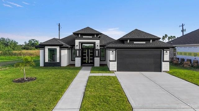 Prairie-style home with a front yard and a garage