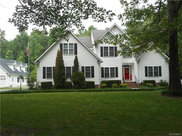 front view showing large detached garage on left.