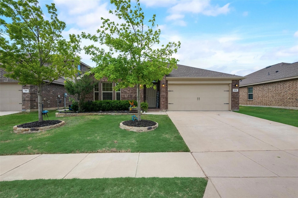 View of front of home with a garage and a front yard