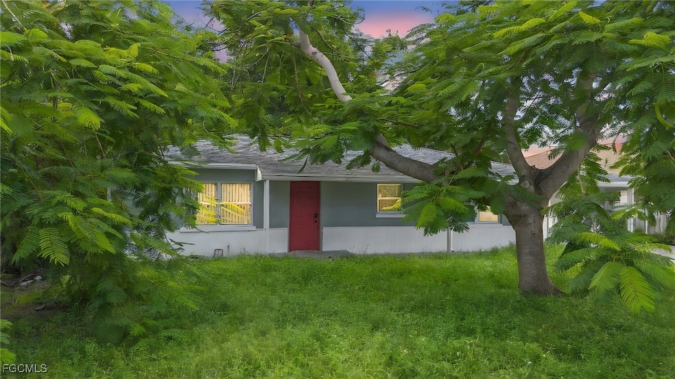 View of front of property featuring stucco siding and a yard
