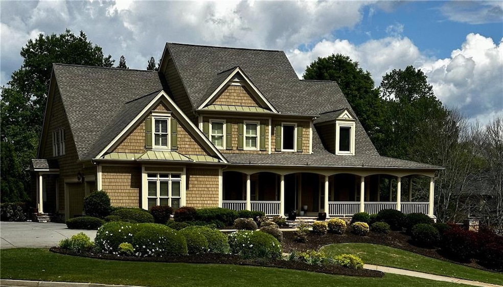 Craftsman style home with a large porch for sitting. Cedar Shake freshly painted.