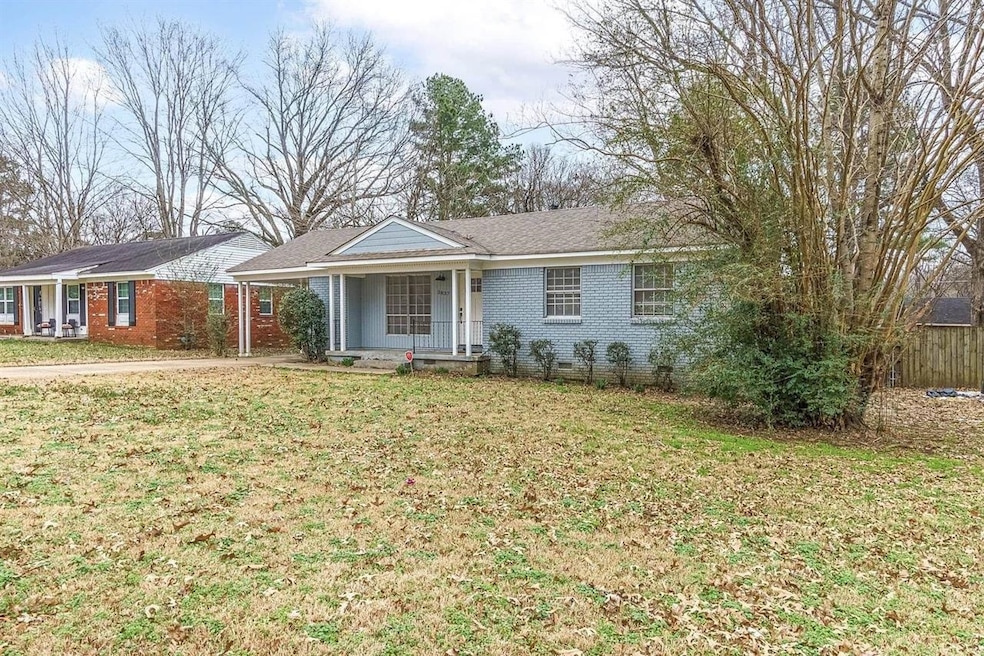 Ranch-style home featuring brick siding, a front lawn, a porch, and crawl space