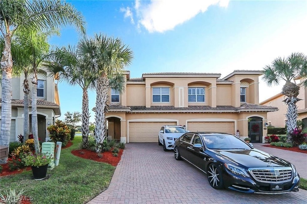 View of front of home featuring a tile roof, stucc