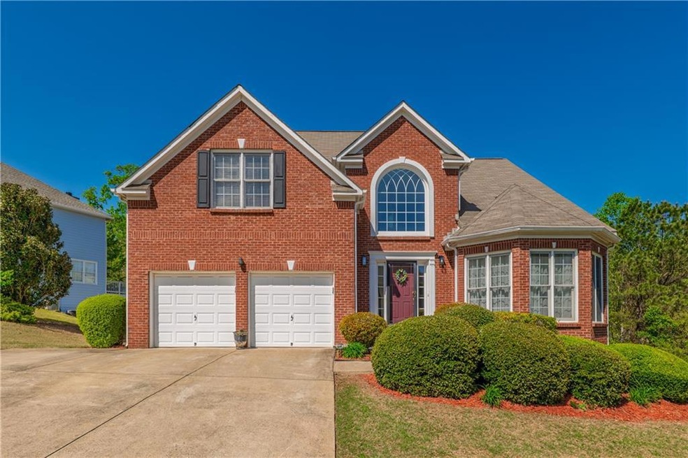 Traditional-style home with concrete driveway, a g