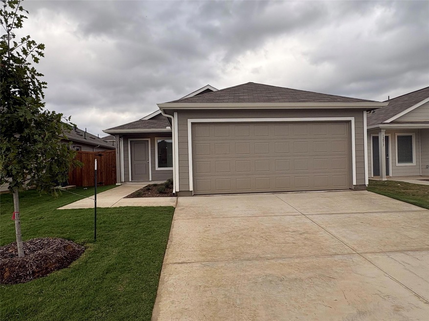 Ranch-style home with a garage and a front yard