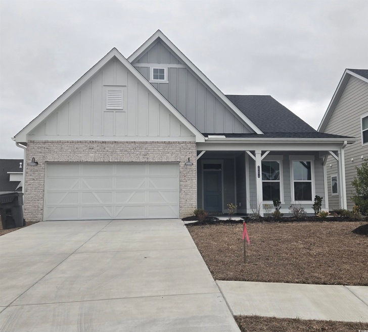 View of front of house featuring a garage and cove