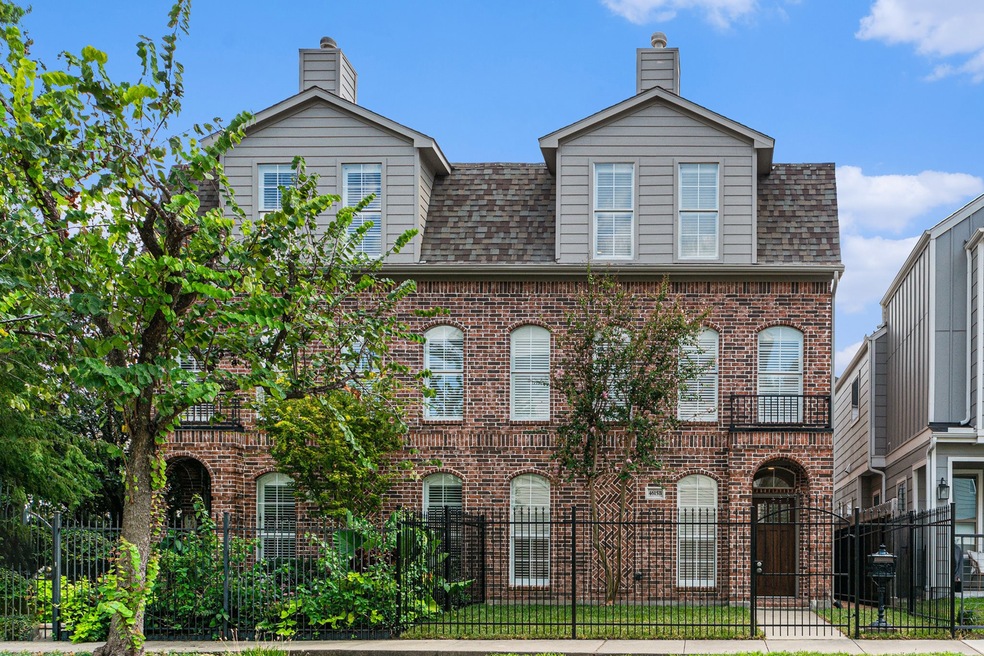 This is a three-story, traditional brick home with