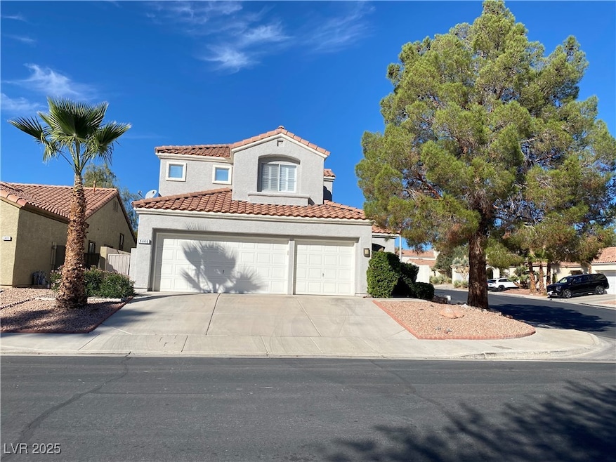 Mediterranean / spanish-style home featuring concrete driveway, stucco siding, and a tile roof