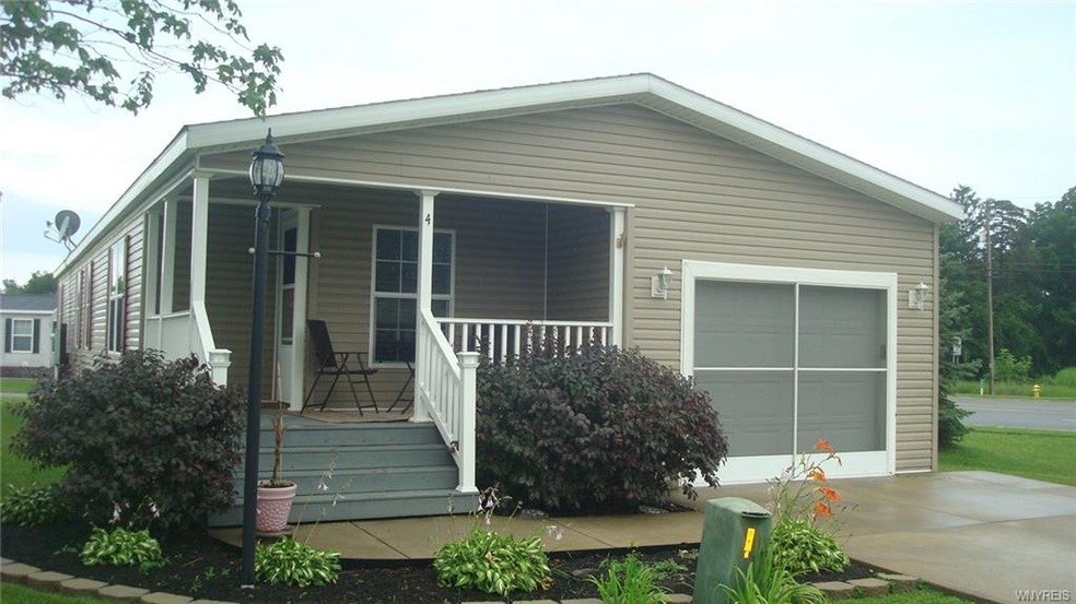 Front view of beautifully maintained home with por