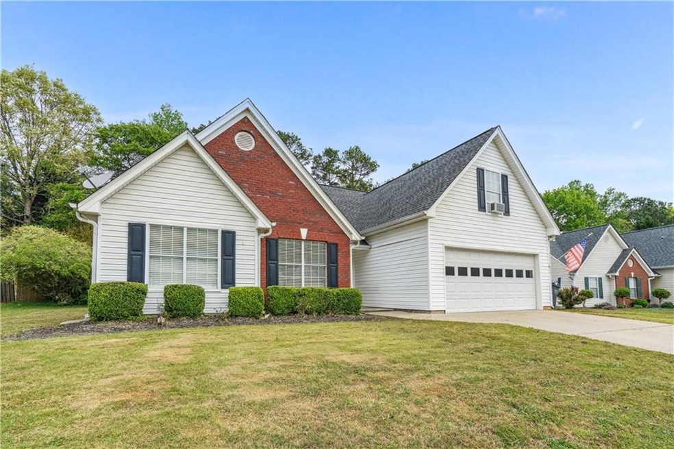 Front facade featuring a front lawn and a garage