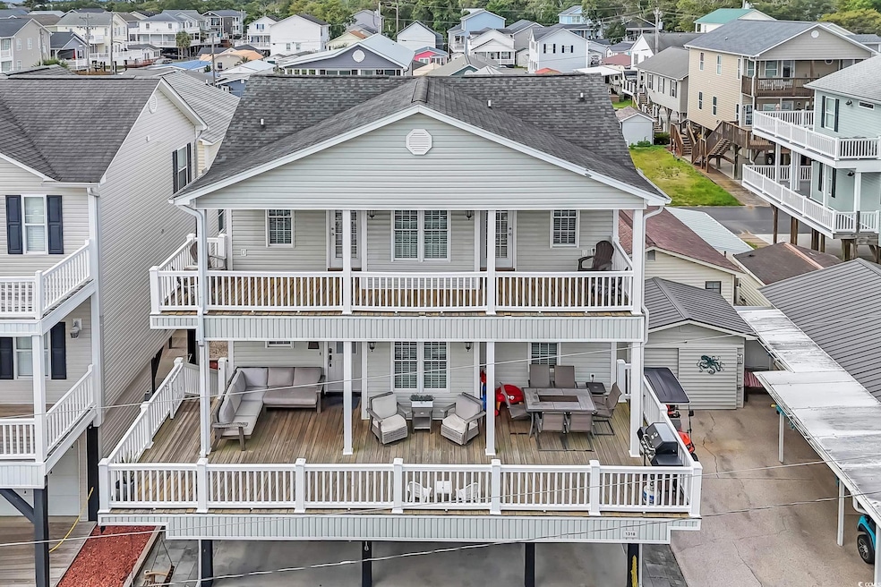 View of front of property featuring roof with shingles, a residential view, and an outdoor living space