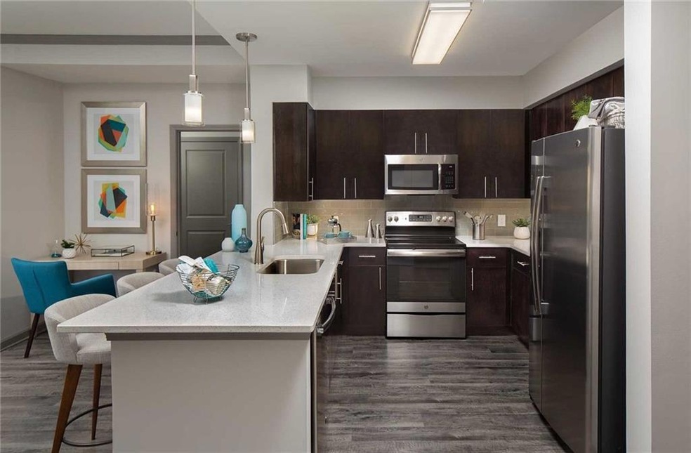 Kitchen with a kitchen breakfast bar, sink, dark h