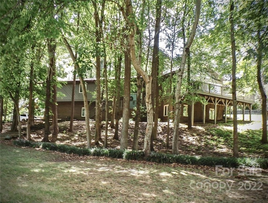 Front of home surrounded by beautiful mature trees