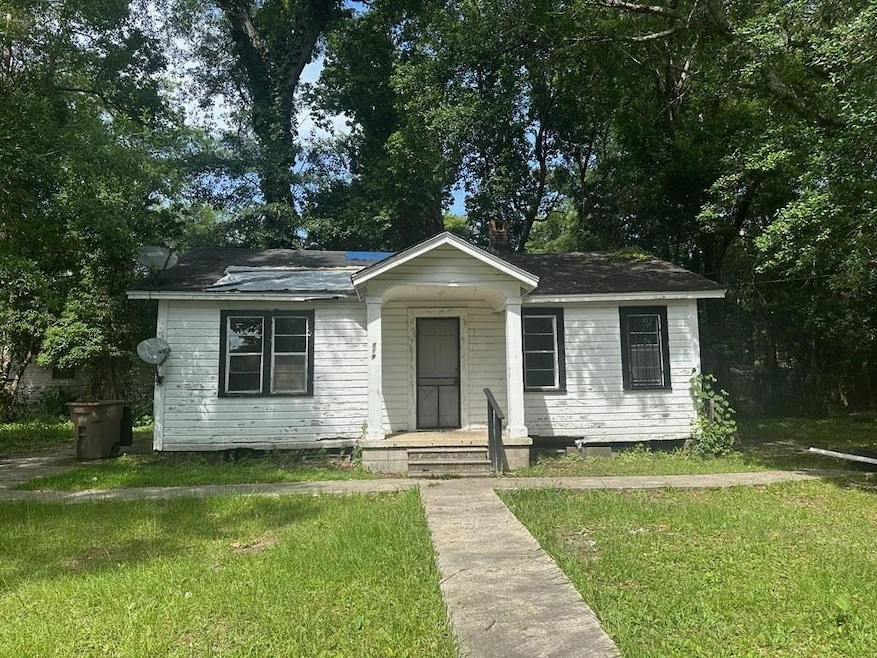Bungalow-style house with a front lawn