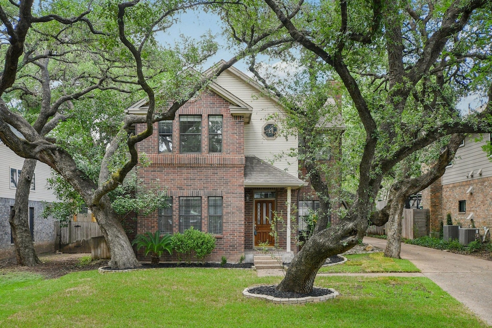 Traditional-style house with brick siding and con