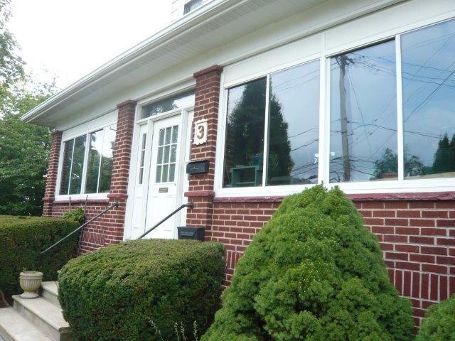 Welcoming front porch.  House sits high on the lot