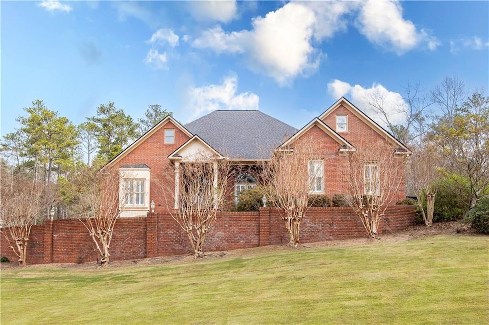 View of front facade featuring brick siding, a fro