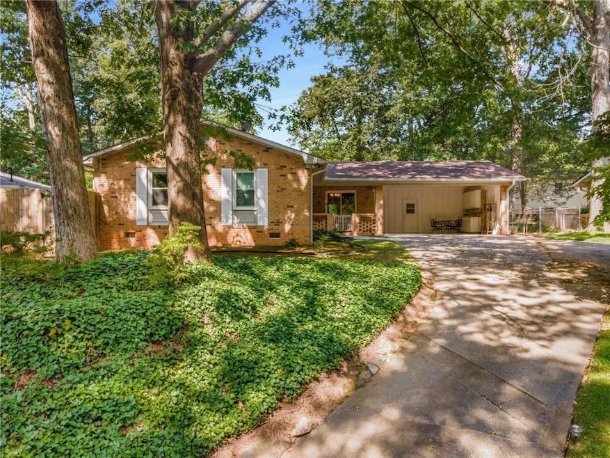 Ranch-style home with a front yard and a carport