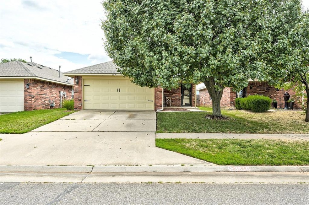 View of front of home with a front yard and a gara