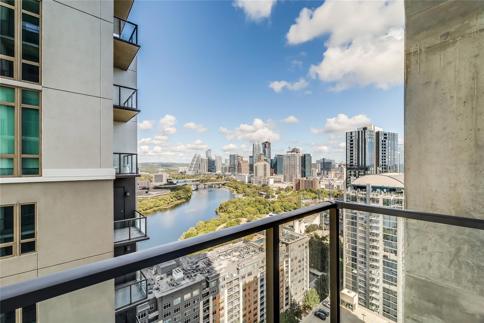 Balcony featuring a water view and a view of city
