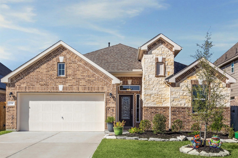 This charming home features a mix of brick and sto