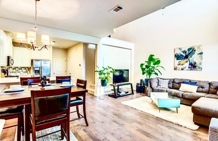 Dining area featuring light wood finished floors and a chandelier
