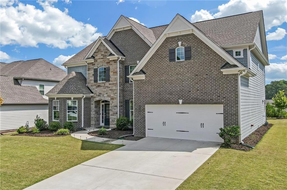 View of front of house with a front yard and a gar