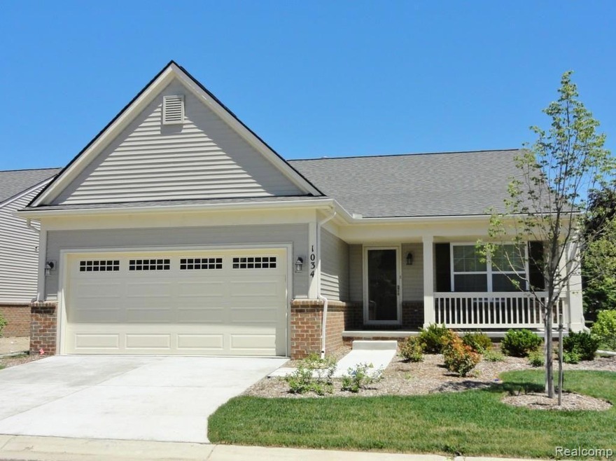 Detached condo with charming front porch.