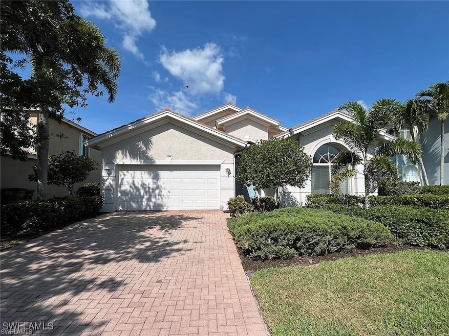 Single story home featuring decorative driveway, a