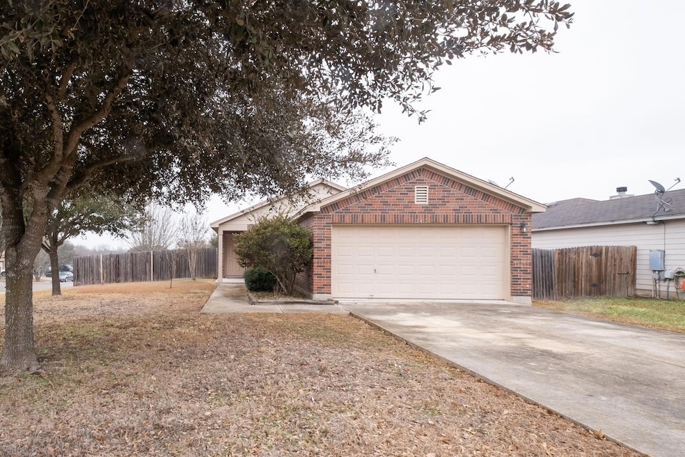 Single story home featuring brick siding, concret